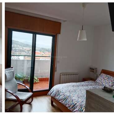 A cozy bedroom with floral bedding, a wooden chair, dresser, nightstand, pendant light, and balcony access. Scenic city view through sliding glass doors. Bright, airy atmosphere.
