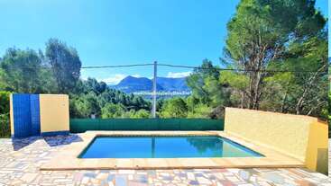The image depicts a serene outdoor scene featuring a pool and surrounding greenery, with a fence in the background, evoking a sense of tranquility and relaxation. The overall atmosphere is peaceful and idyllic.