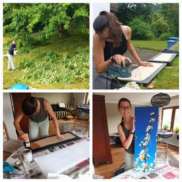A colagem mostra uma mulher aparando galhos de árvores, lixando uma moldura, pintando-a dentro de casa e exibindo alegremente uma obra de arte finalizada com galhos floridos contra um céu azul.