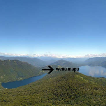 The image depicts a serene landscape featuring mountains, a lake, and a blue sky with clouds, with an arrow pointing to the text \"wenu mapu\" in the center.