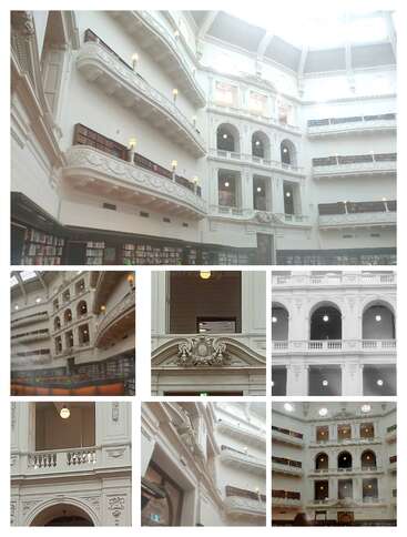 The image depicts the interior of a large white building with ornate details, featuring multiple levels of balconies and archways, likely a library or museum.