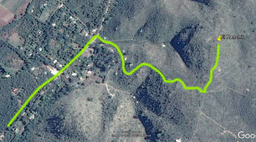 The image shows a map with a winding road, featuring a green area with a red line, and a gray area with a red line, likely used for navigation or planning purposes.