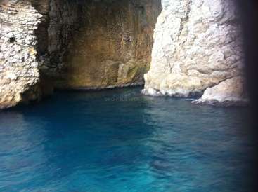 La imagen representa una cueva serena con una gran masa de agua y formaciones rocosas blancas, que evocan una sensación de tranquilidad y belleza natural.