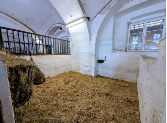 The image shows a split screen: on the left are document templates, while on the right are horse stables, tack room, indoor arena, and grassy pasture.