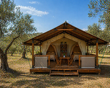 Esta imagem mostra uma elegante barraca de glamping em um tranquilo olival. A barraca conta com móveis de madeira, duas camas e uma aconchegante área de estar ao ar livre.
