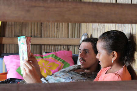 volunteer reading and teaching english to local kid