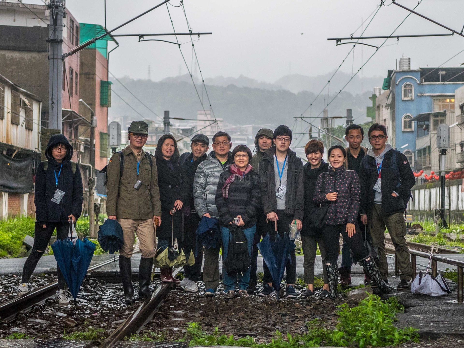 group photo of taiwan workaway project hosts and travellers on an outdoor railway rural destination