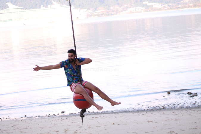 solo travel digital nomad swinging on beach happiness