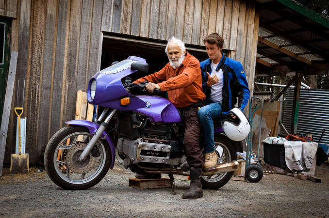 senior and young traveller travel by motorbike together