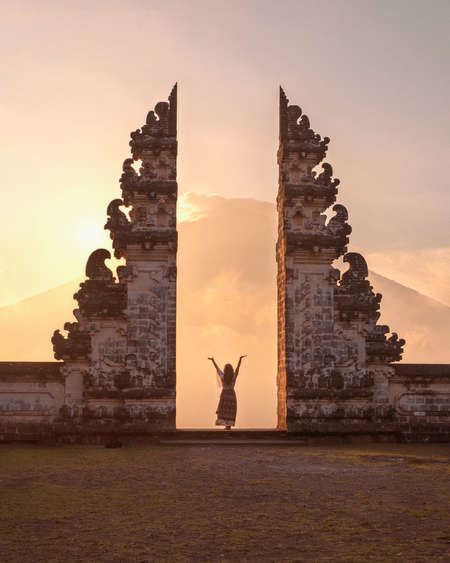 solo female taveller Bali admire heritage temple sunset