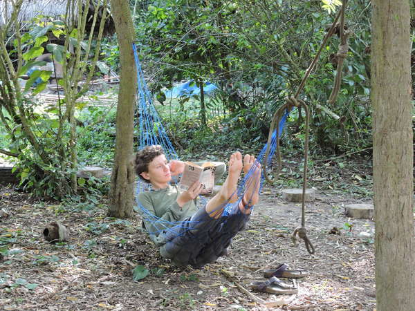 unplugged traveller in amazon jungle relax hammock with book