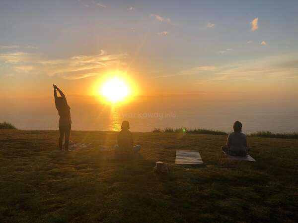 stretch relax nature grass yoga group trio enjoy sunset over sea