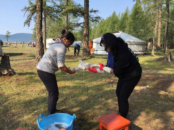 yurt camp fun volunteer chores work exchange washing outdoors with kids