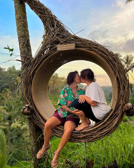 kissing wow couple in tropical romantic nest