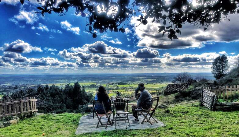 pair of travellers relaxing with morning drinks and enjoying clear weather outdoors