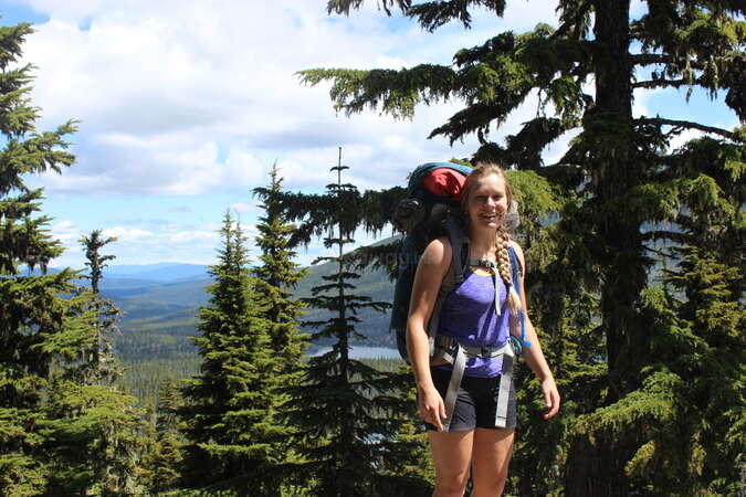 solo female backpacking and hiking through forest