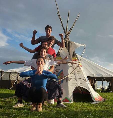 group of workaway travellers posing in front of a teepee