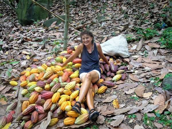 woman sitting on the floor next to cocoa farmstay experience workaway