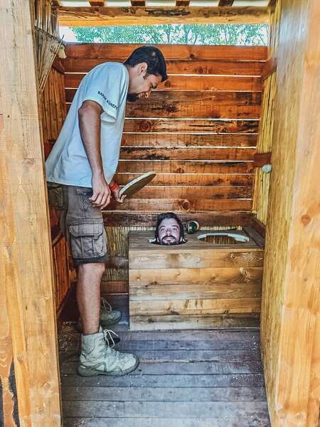 funny picture of man sticking head out of built toilet