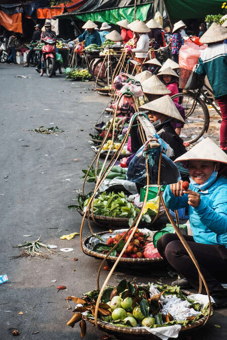 group of local ladies selling street food in vietnam