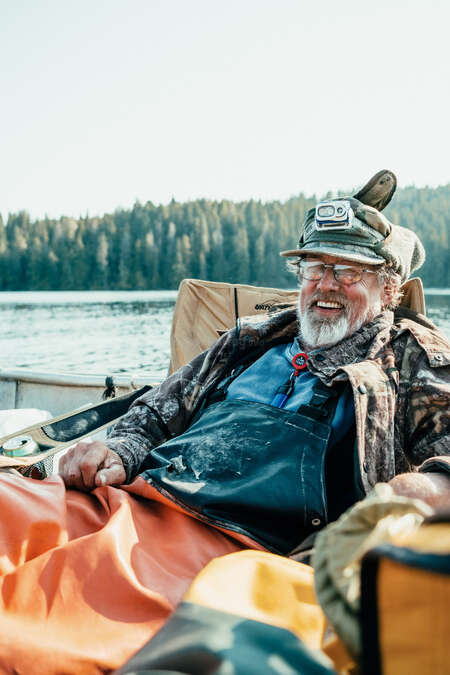 Alaska host Jerry smiling and sitting on a boat sailing 