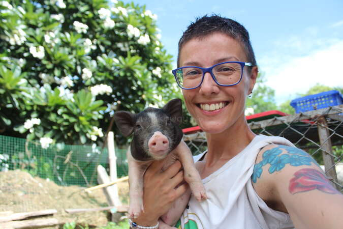 solo female posing next to piglet