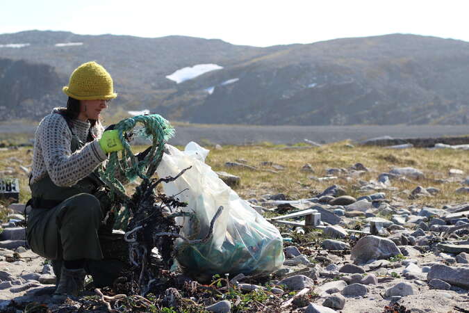 solo female volunteer picking litter in Norway