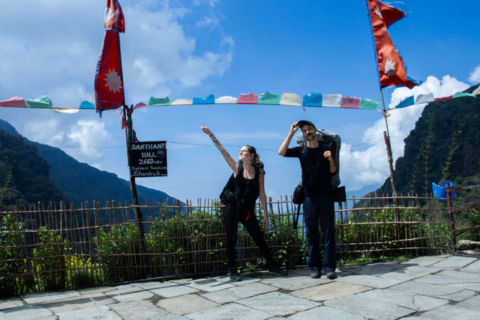 achieve-travel-bucket-list-goals travel couple pointing at different directions while hiking nepal mountains nature trek