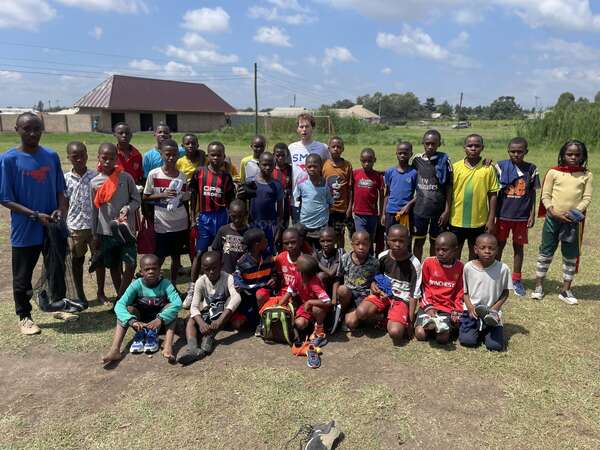 digital-nomad-experience-volunteer-football-coach football academy students in tanzania volunteer remote work digital nomad travel
