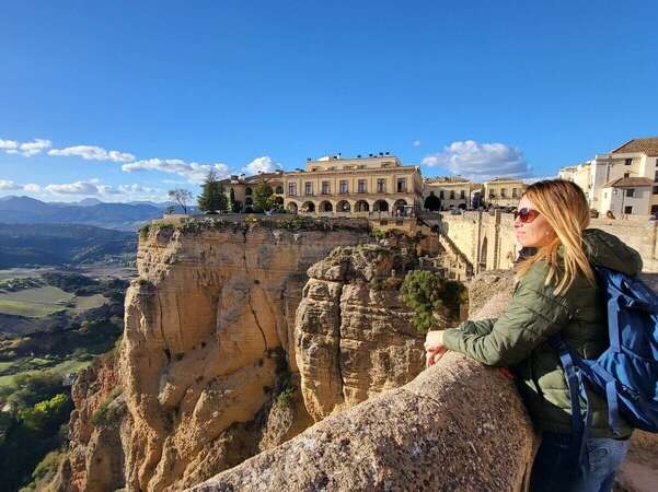 Angelina, the article's author looking at the vast landscape from the Puente Nuevo bridge in Ronda, Andalusia.