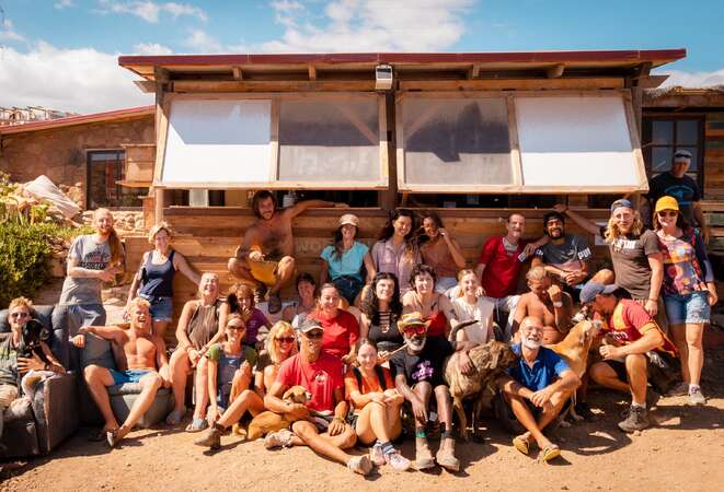 Large group of volunteers posing in front of a traditional finca in Spain
