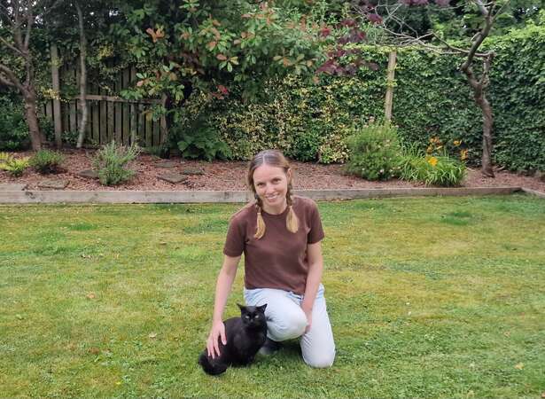 best-places-spain-house-sitting-workaway-gallery Angelina, blog's author with a black cat in the garden while house sitting